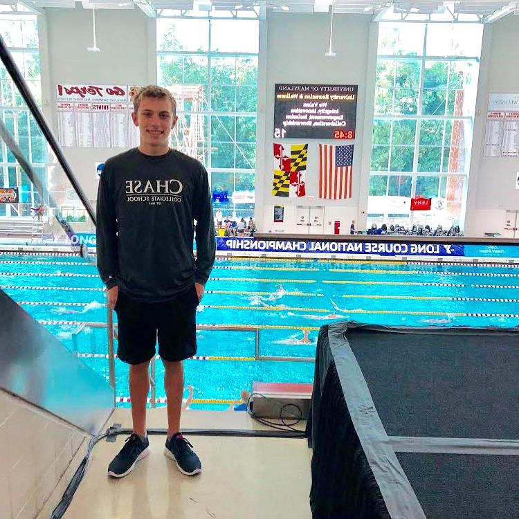 Chase Collegiate student Nate Stellmach stands in front of a swimming pull at the long course national championship.